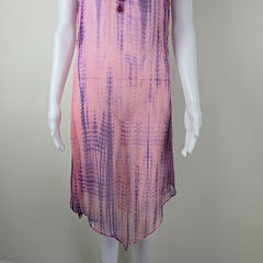 Mannequin wearing a sheer, multicolored fabric dress against a plain background