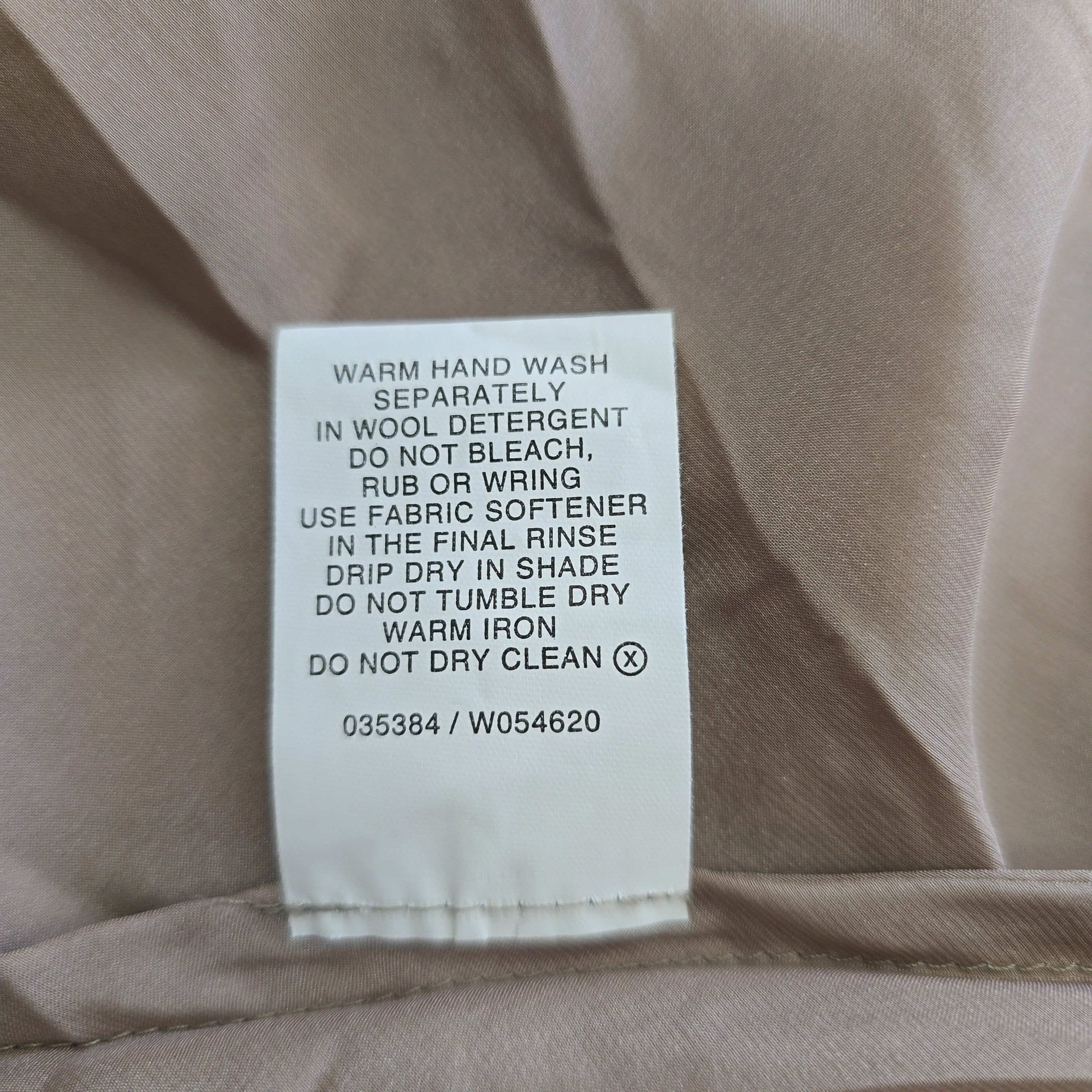 Clothing label on a beige fabric background