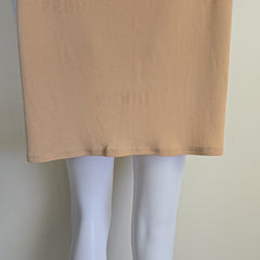 Mannequin wearing a beige top on a plain background