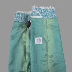 Green fabric with a label on a tiled floor