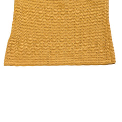 Yellow knitted tank top on a light background