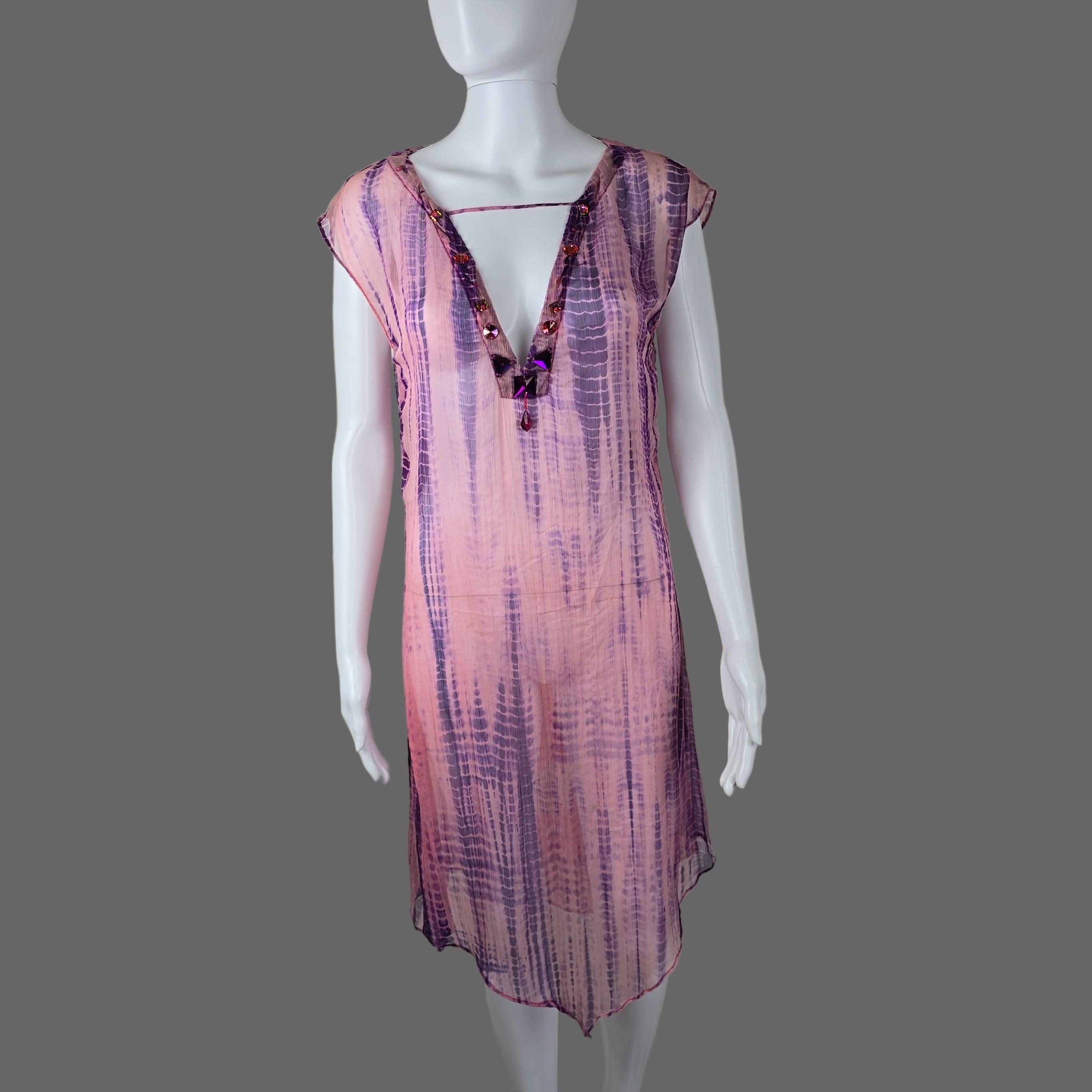 Mannequin wearing a pink and purple dress on a plain background