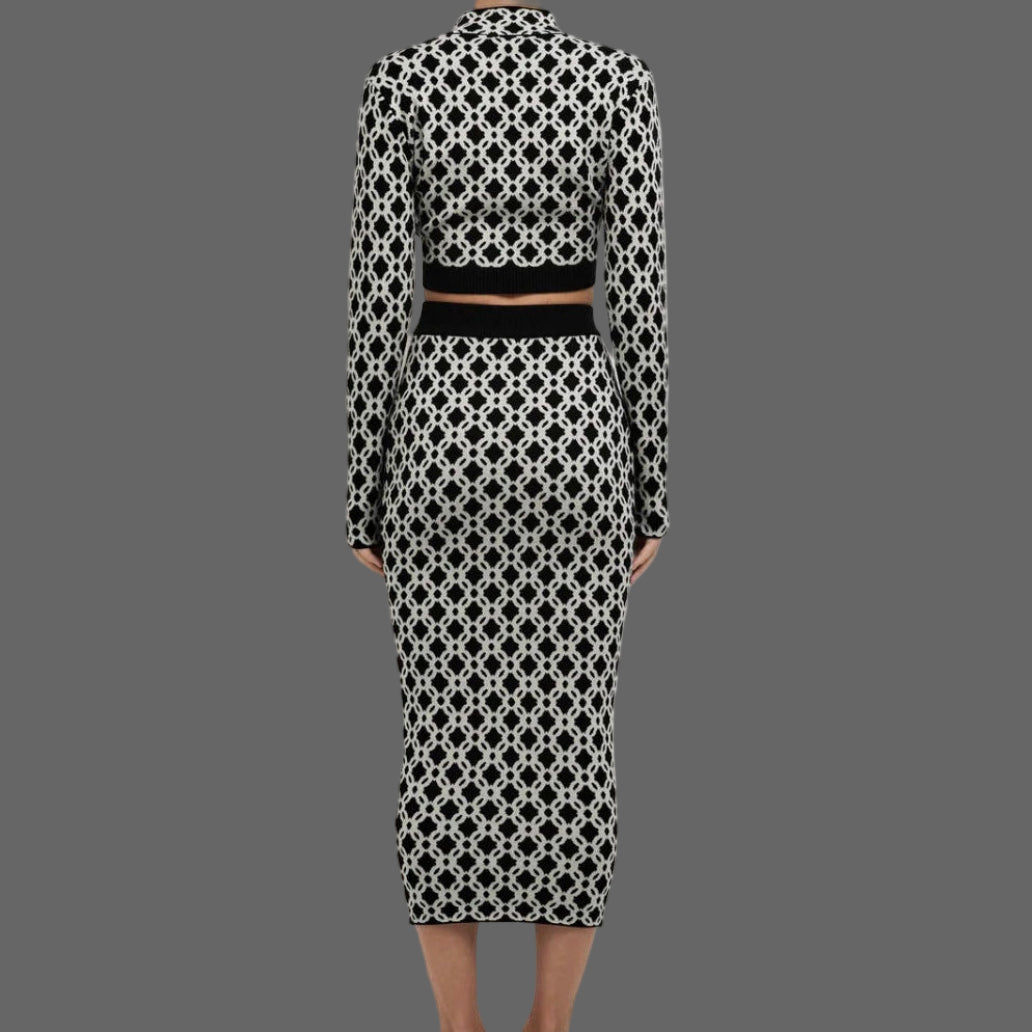 Person wearing a black and white patterned outfit on a white background