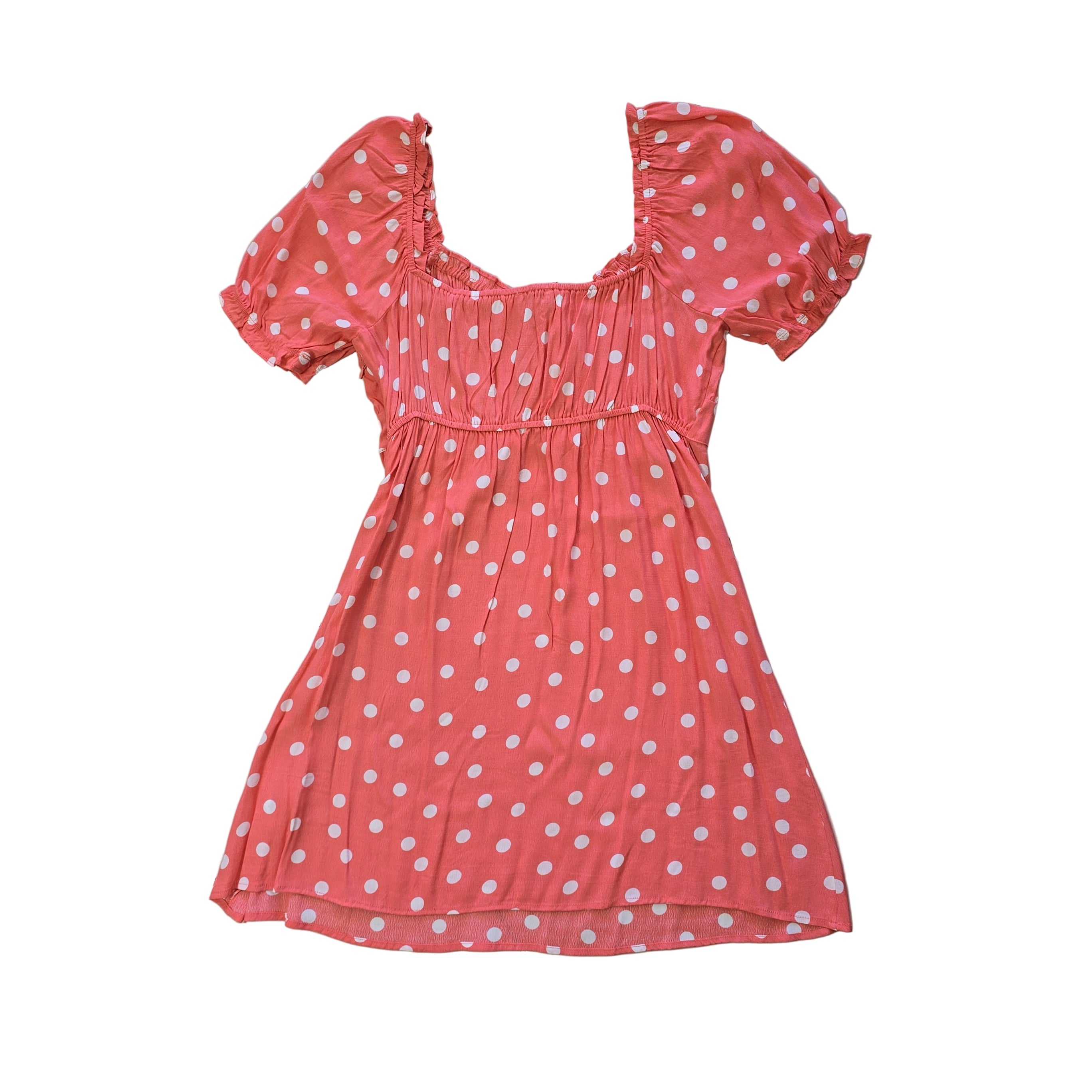 Pink polka dot dress on a tiled floor