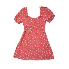 Pink polka dot dress on a tiled floor