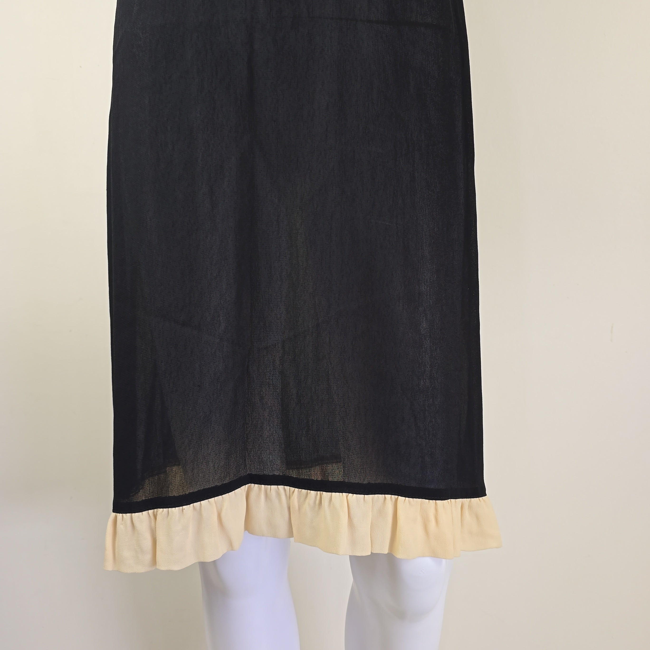 Black fabric with beige trim on a neutral background