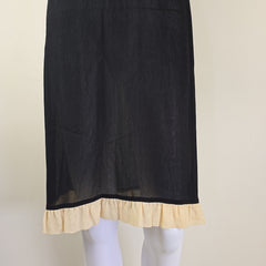 Black fabric with beige trim on a neutral background