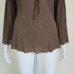 Brown fabric with gold studs on a mannequin arm against a white background