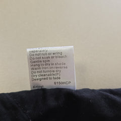 Clothing label with care instructions on a beige background