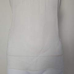 Close-up of a white top with a neutral background