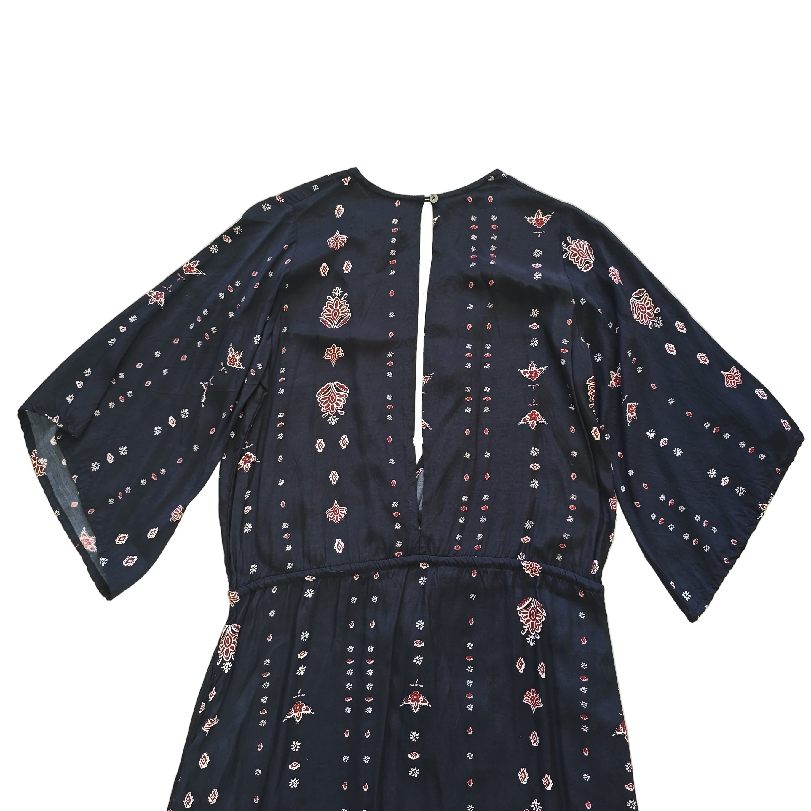 Black dress with white and pink patterns on a light background