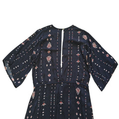 Black dress with white and pink patterns on a light background