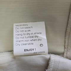 Clothing label with care instructions on a fabric background