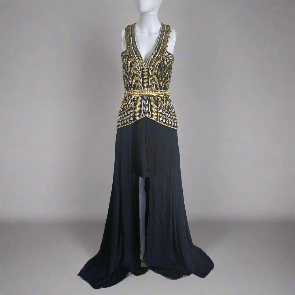 A Sass & Bide black floor-length dress with intricate gold embellishments on the bodice and waist, featuring a cut-out back and a flowing skirt.