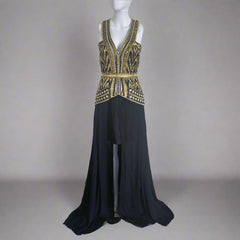 A Sass & Bide black floor-length dress with intricate gold embellishments on the bodice and waist, featuring a cut-out back and a flowing skirt.