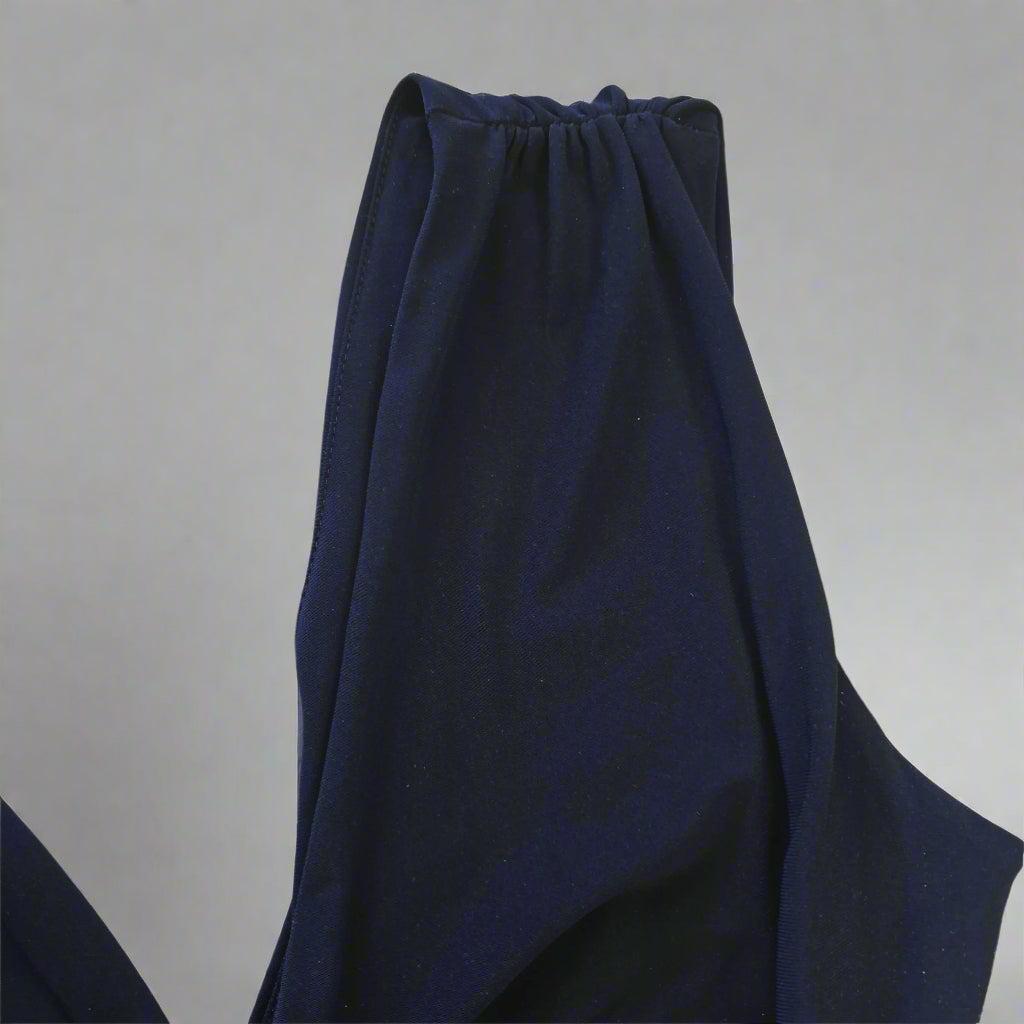 Navy blue dress on a light gray background