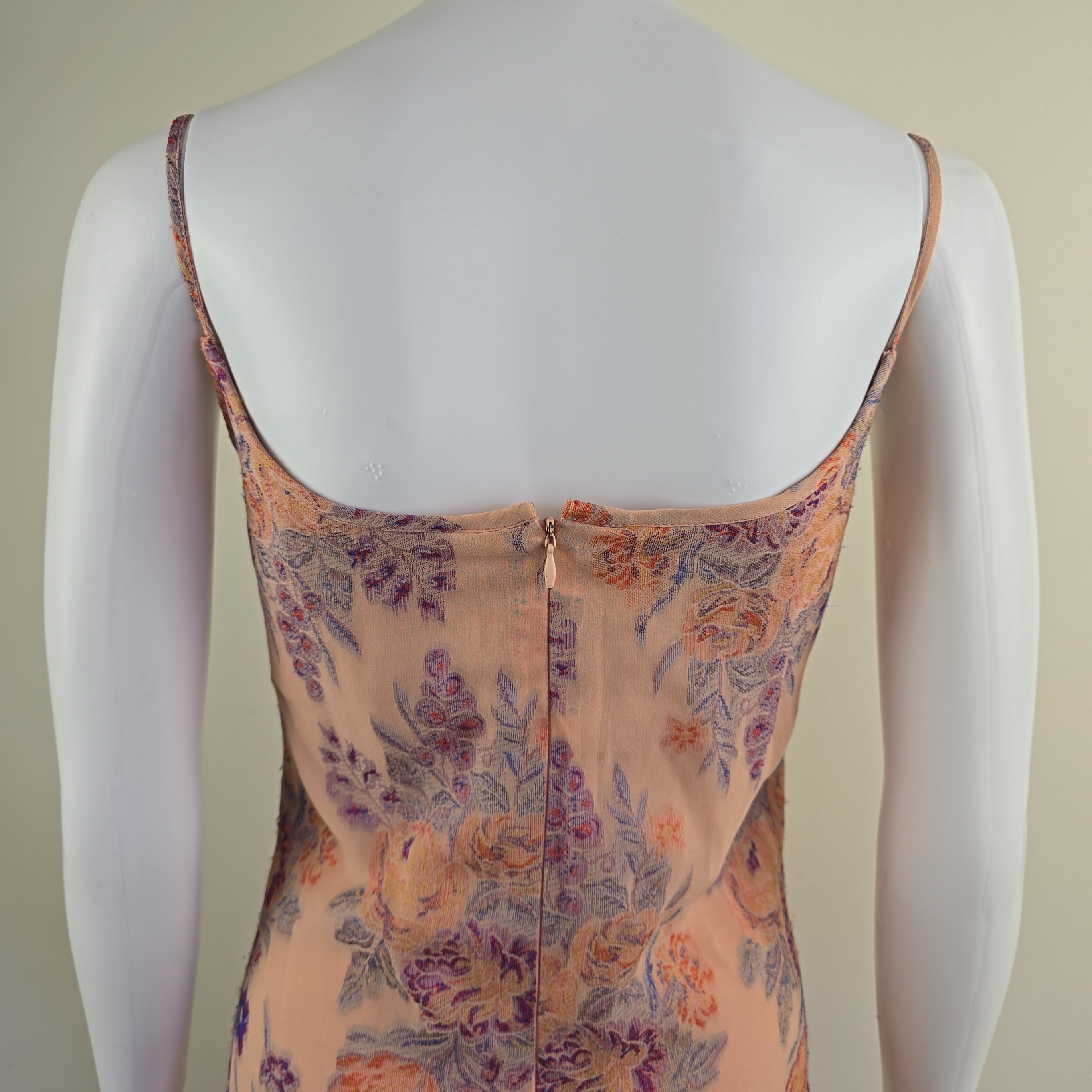 Floral-patterned bra on a mannequin against a beige background