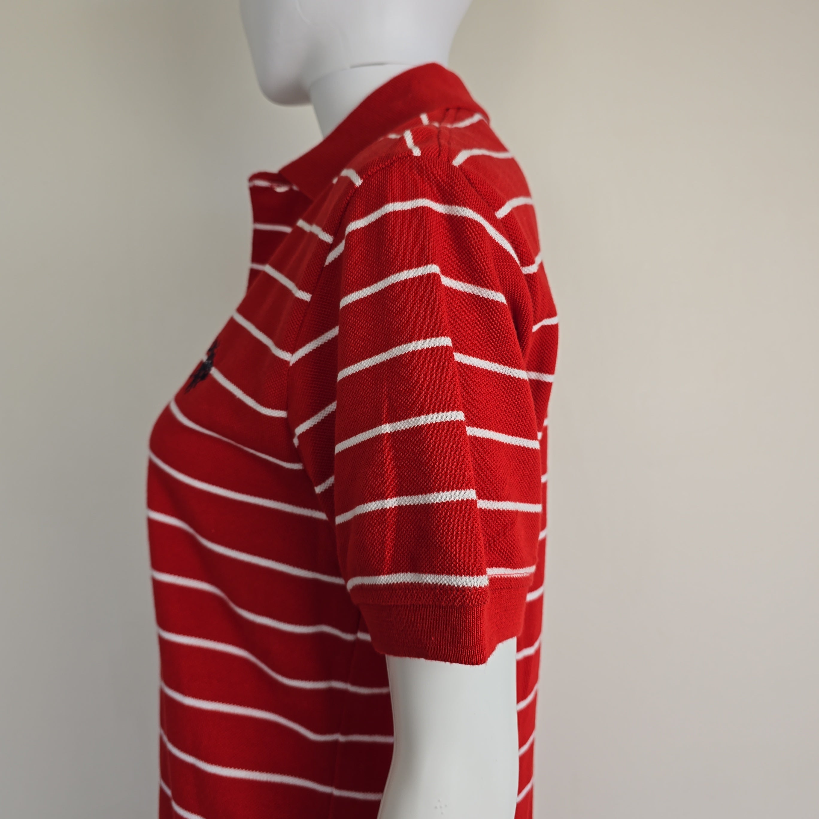Red and white striped garment on a mannequin against a plain background