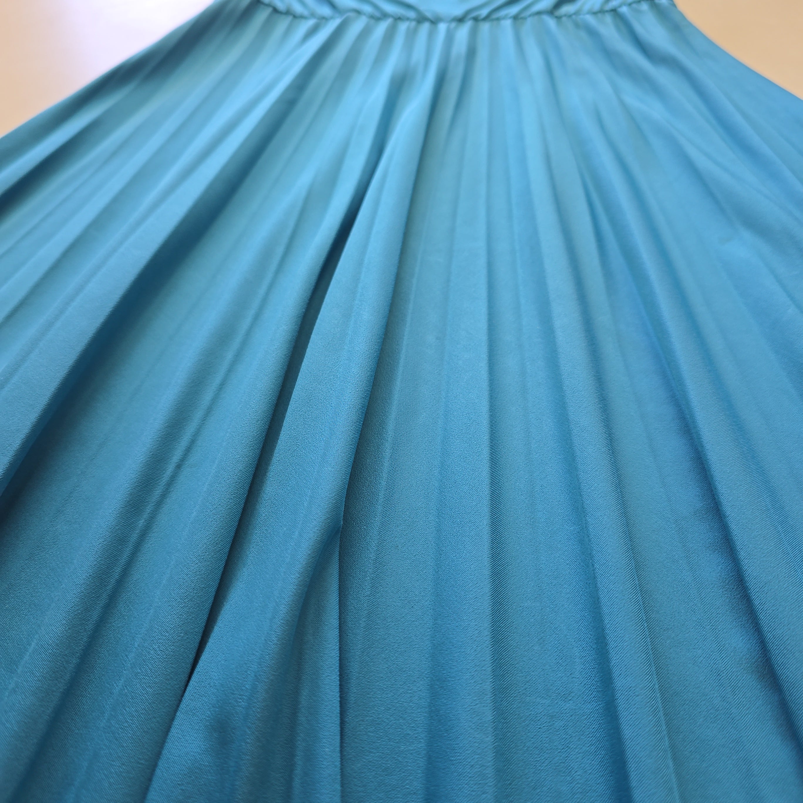 Close-up of a pleated turquoise fabric
