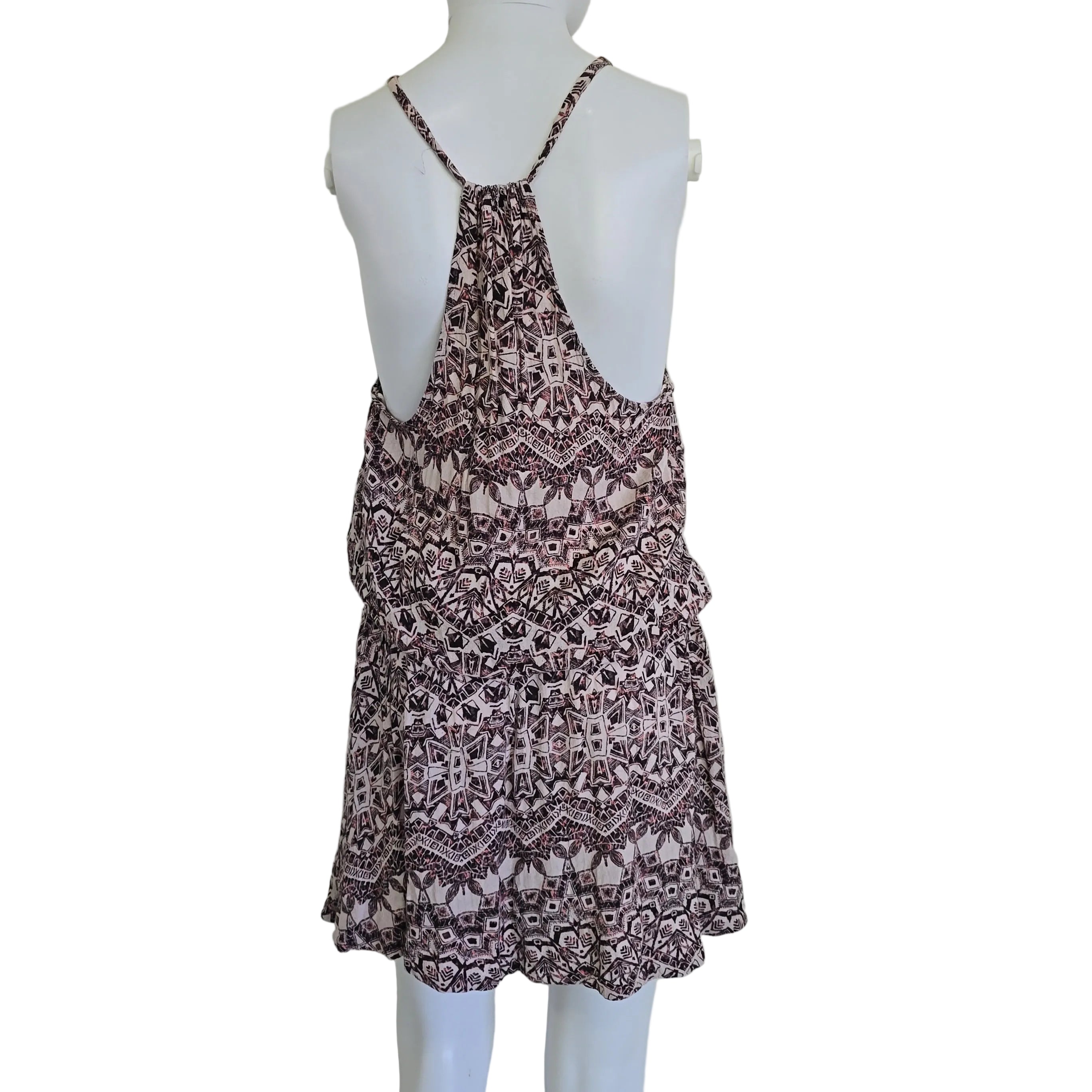 Patterned dress on a mannequin against a plain background