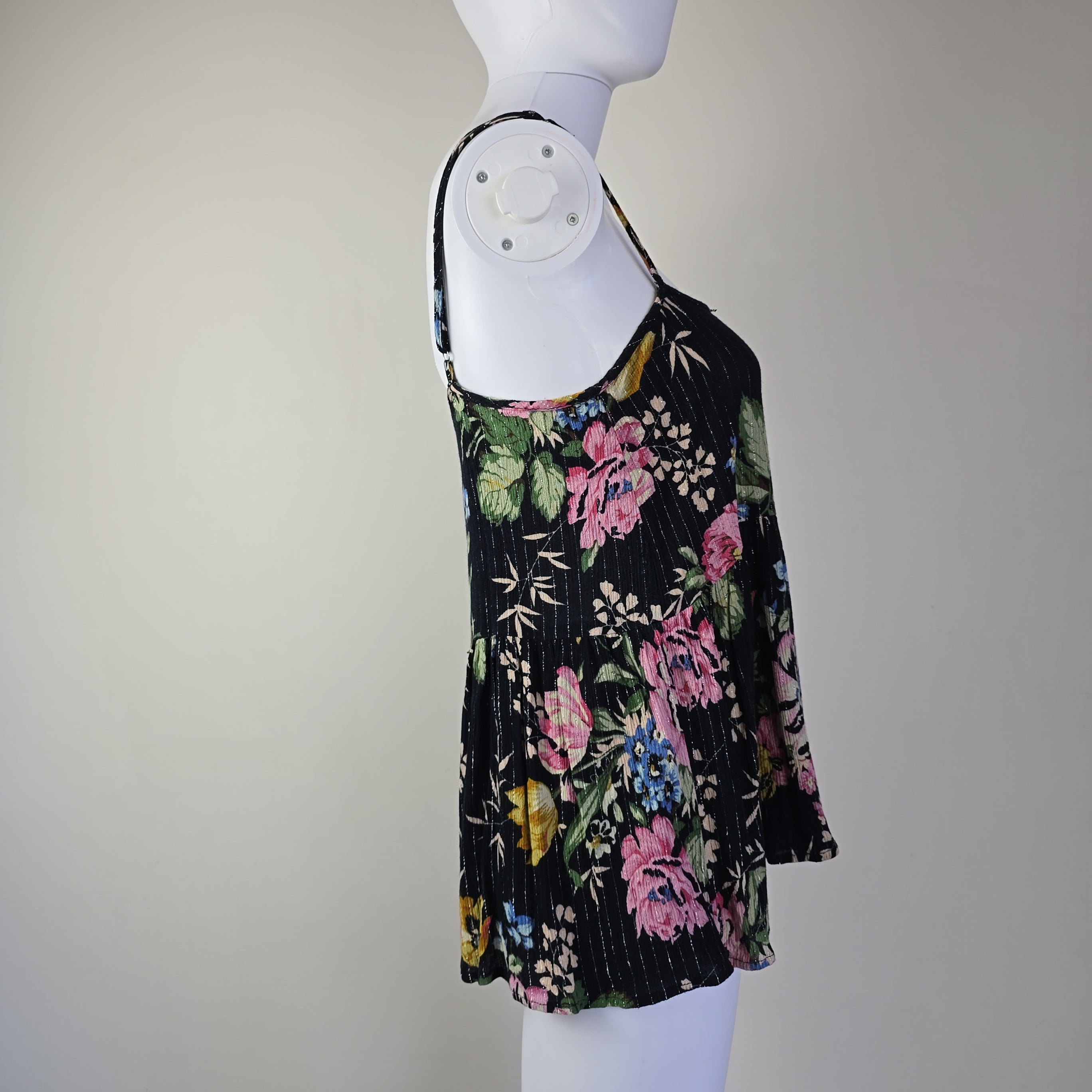 Black floral-patterned top on a light background