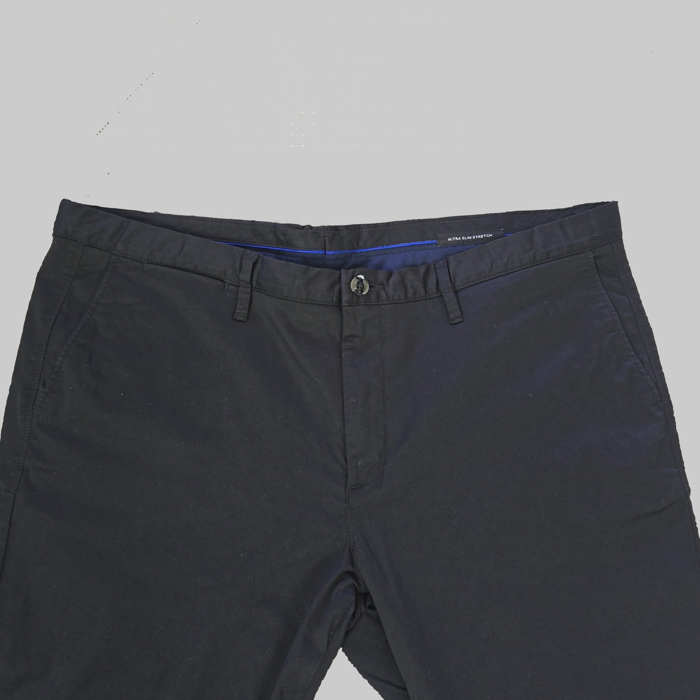 Dark black pants on a tiled floor