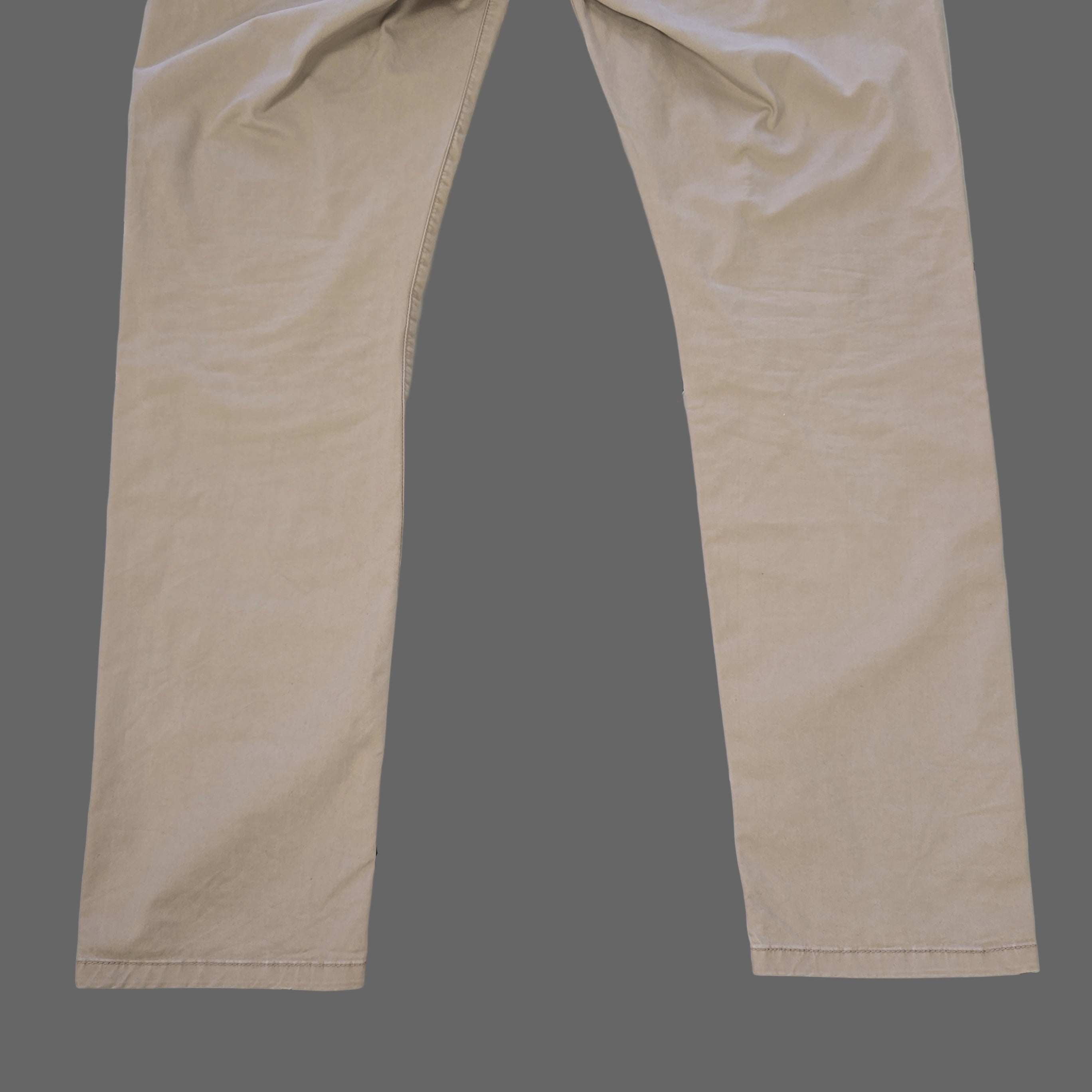 Beige pants laid flat on a tiled floor