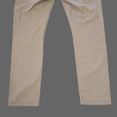 Beige pants laid flat on a tiled floor