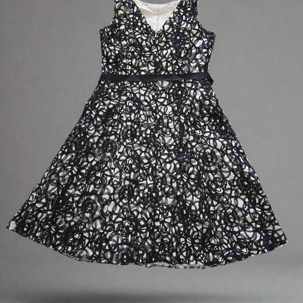 Black lace dress on a tiled floor