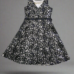 Black lace dress on a tiled floor