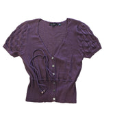 Purple textured garment on a tiled floor