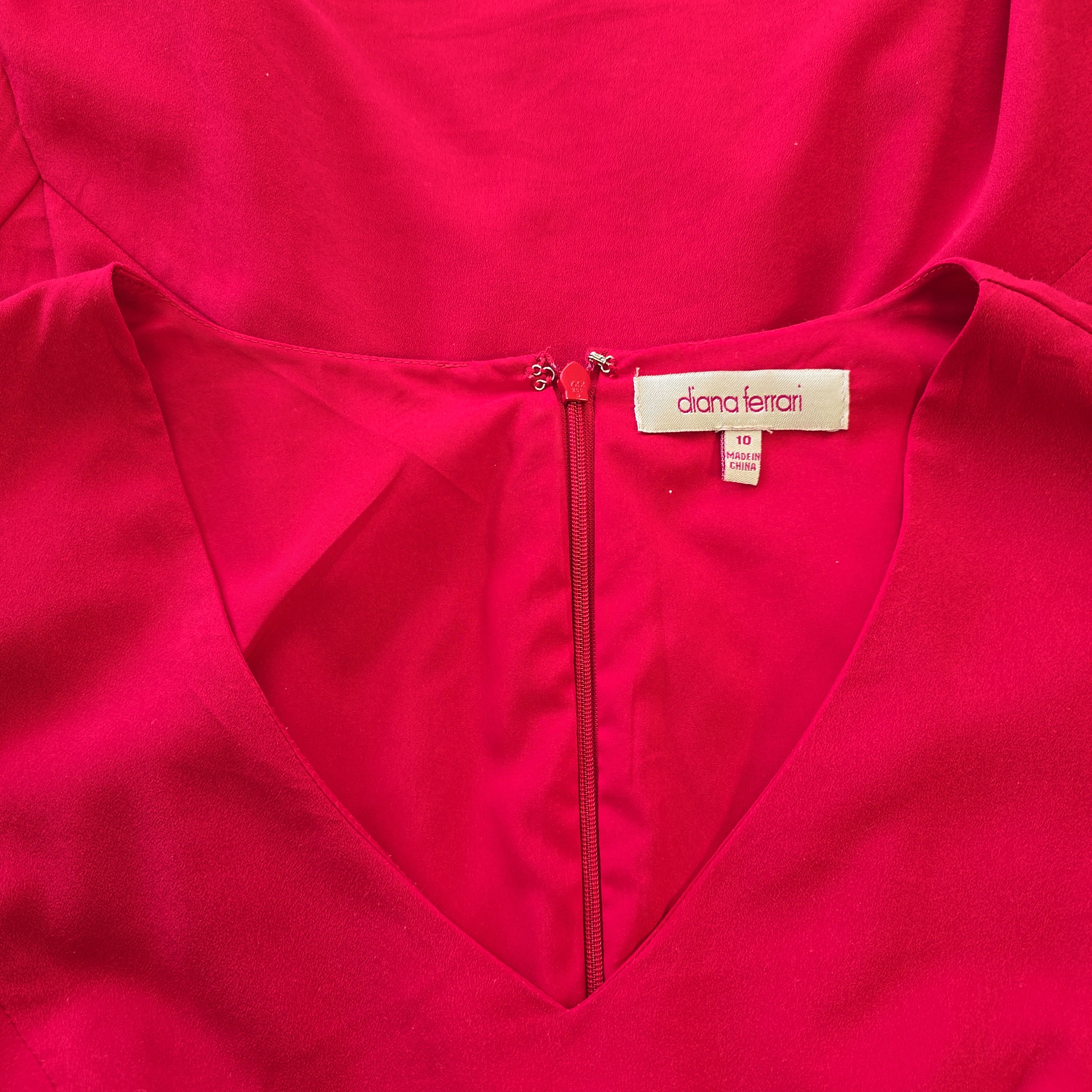 Close-up of a red garment with a brand label on a matching red background