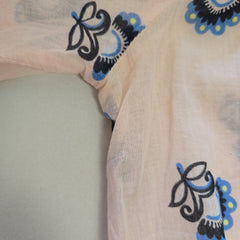 Close-up of a fabric with floral patterns in black and blue on a beige background