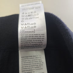 Close-up of a label on a dark fabric background