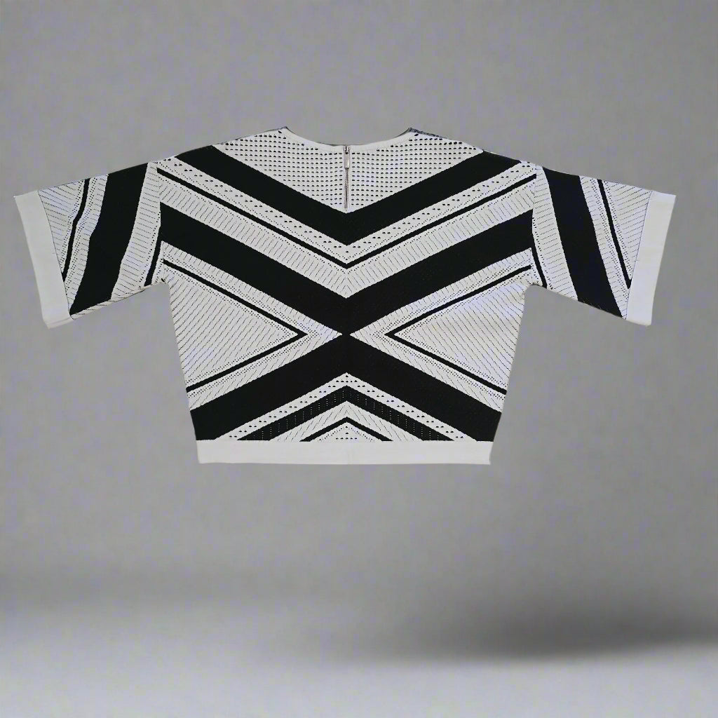 Black and white geometric-patterned top on a tiled floor