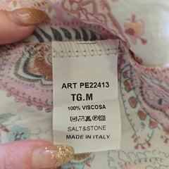 Fabric tag with product details on a patterned fabric background