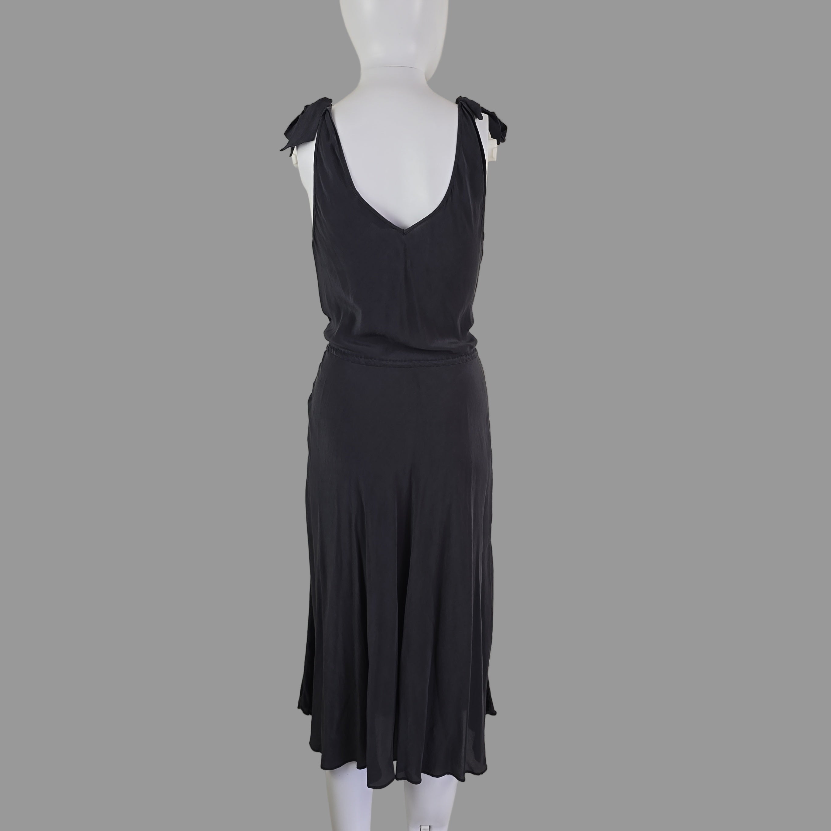 Grey dress on a mannequin against a plain background