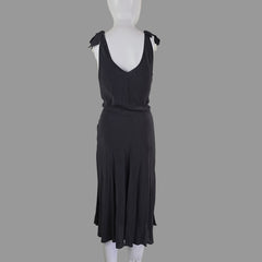 Grey dress on a mannequin against a plain background
