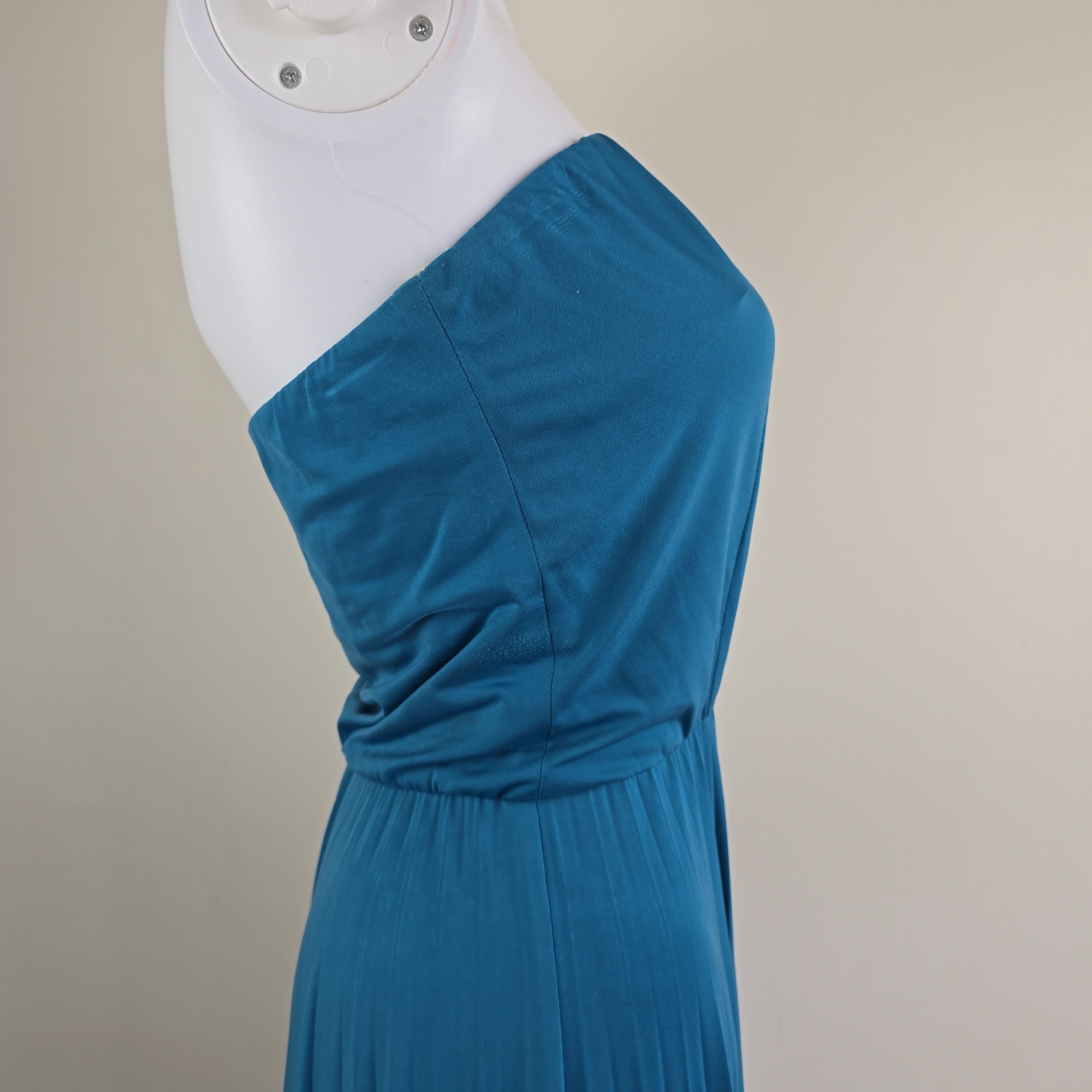 Blue strapless dress top on a mannequin against a beige background