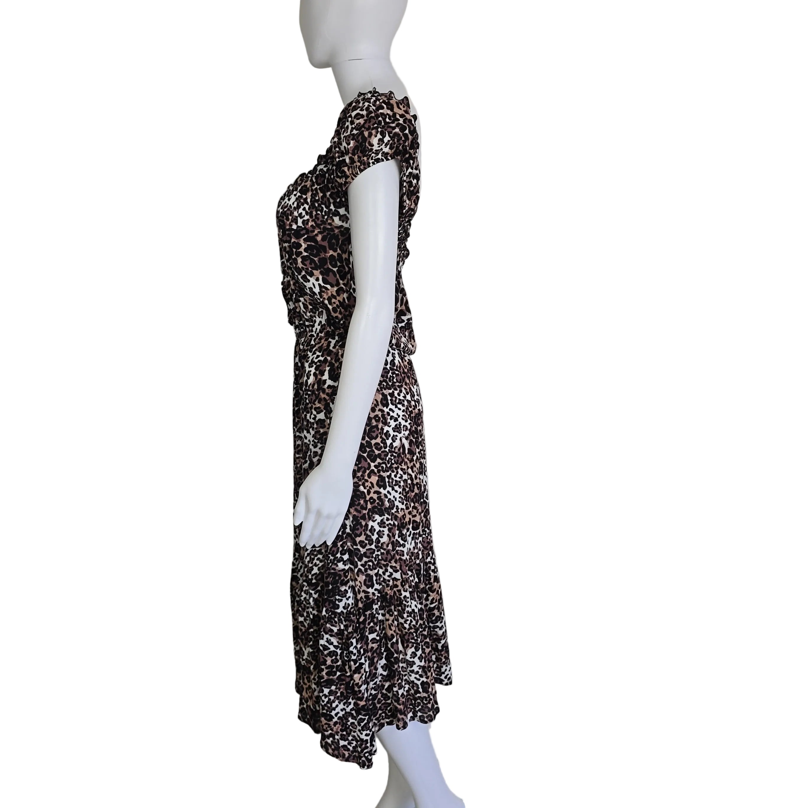 Mannequin wearing a leopard print dress against a plain background