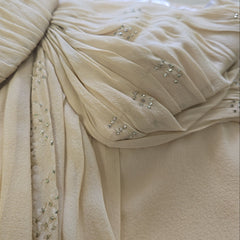 Close-up of a beige fabric with embellishments.