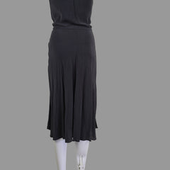 Grey dress on a white mannequin arm against a neutral background