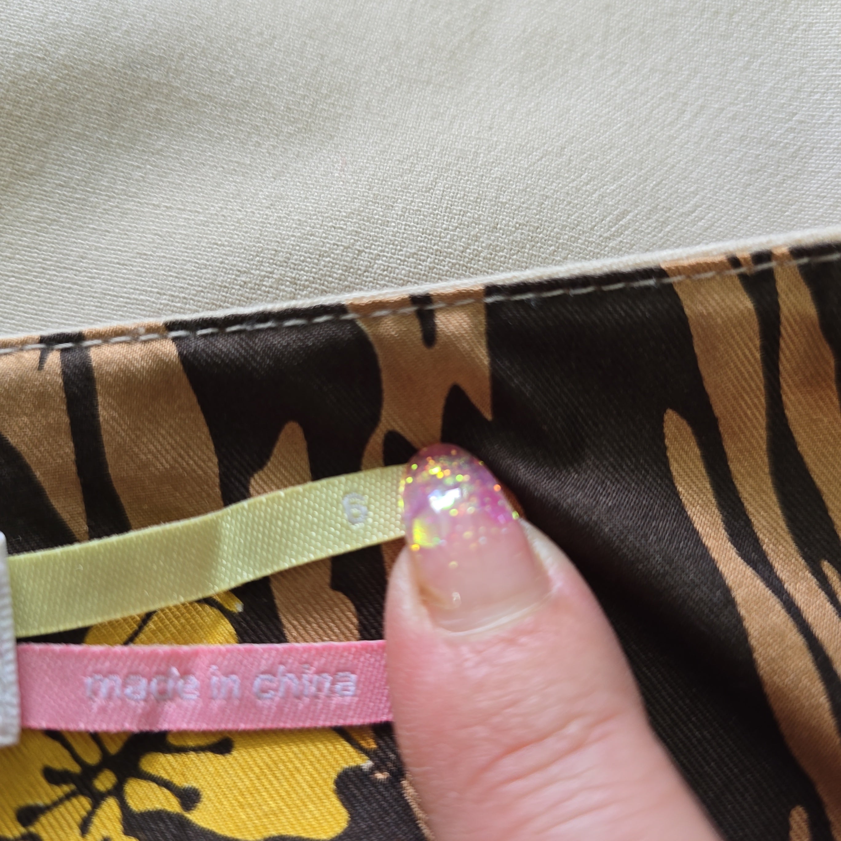 Close-up of a tiger-striped fabric with a visible brand label.