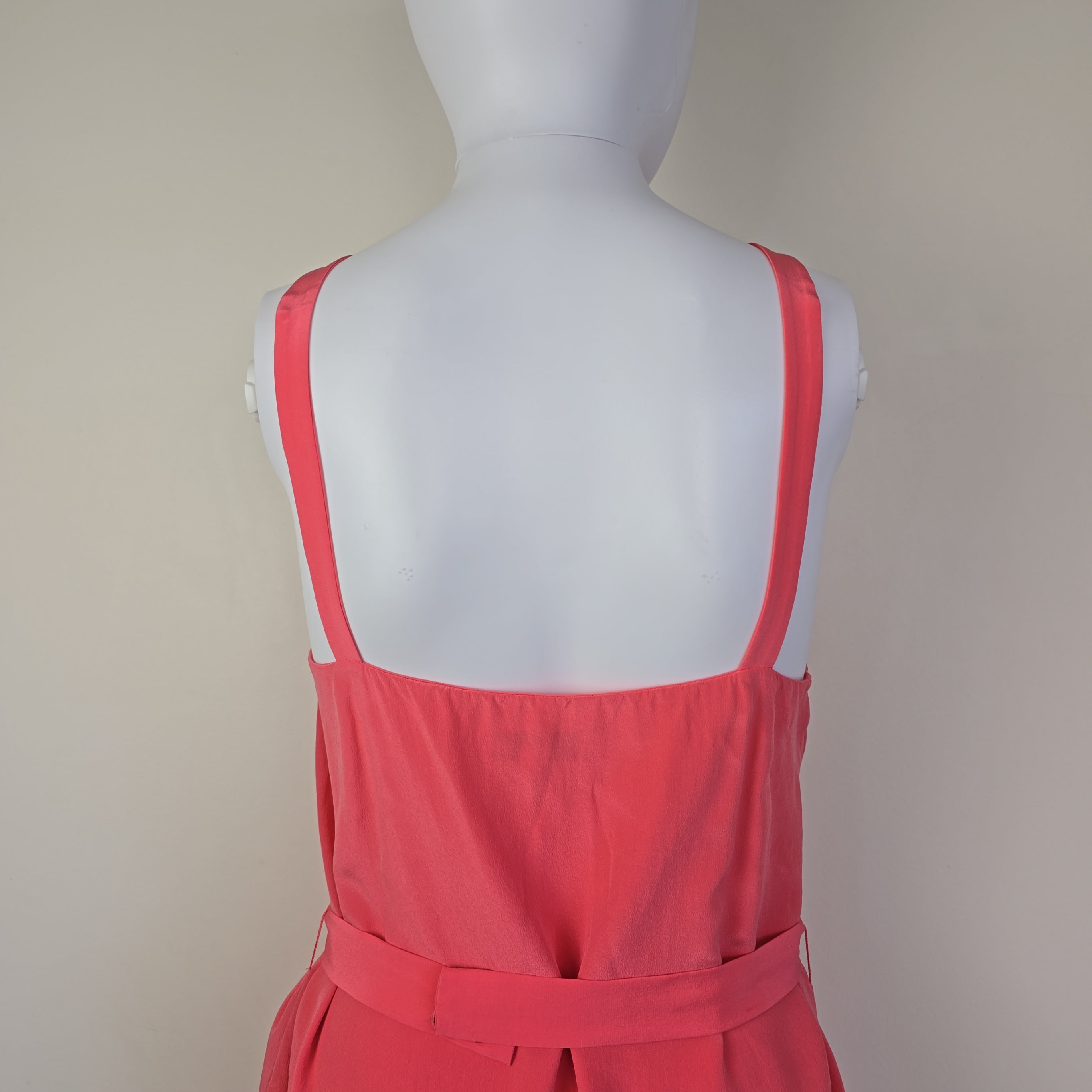 Pink dress with ruffled details on a light background