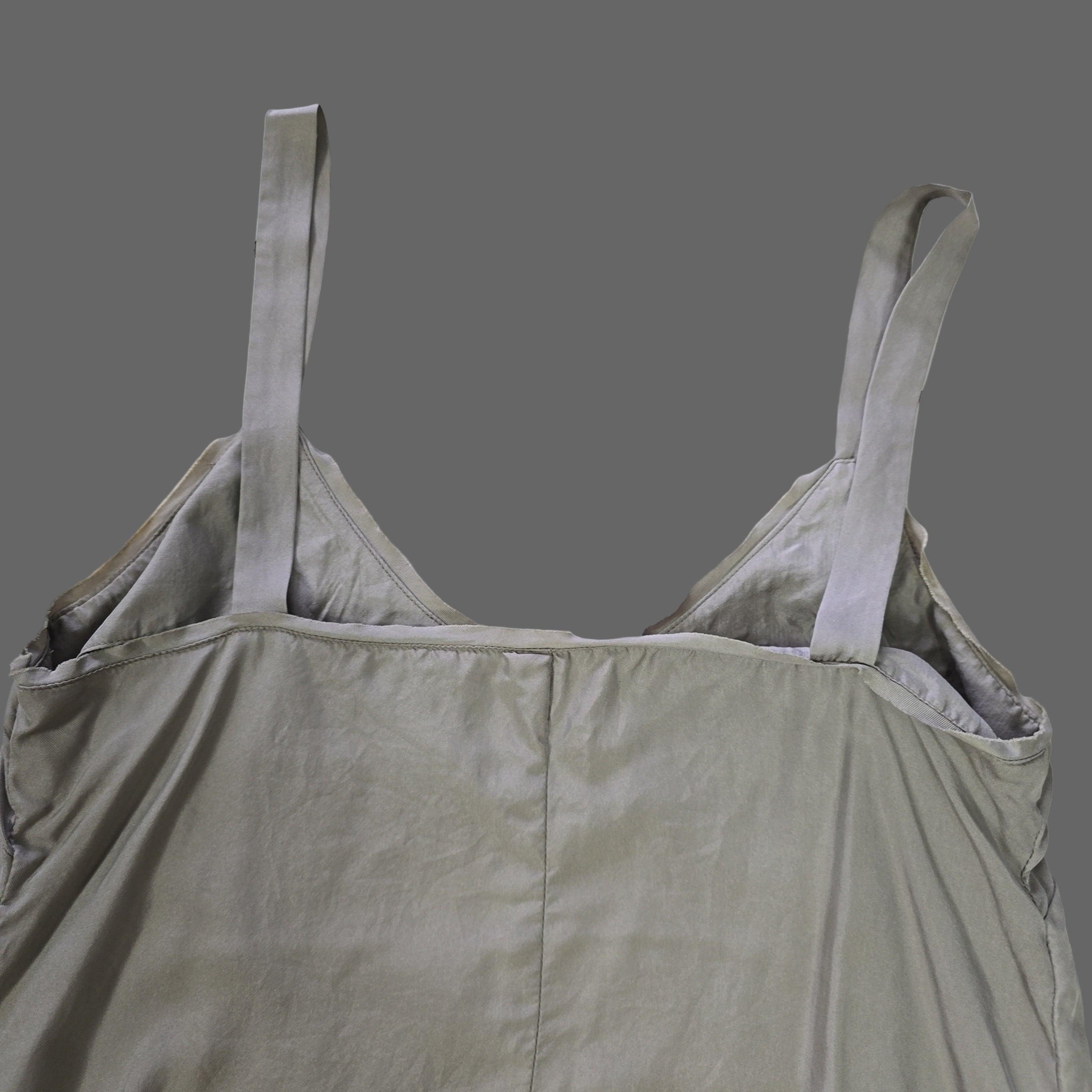 Light gray top with straps on a tiled floor