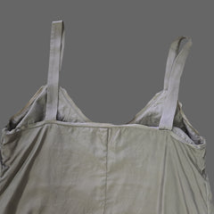 Light gray top with straps on a tiled floor