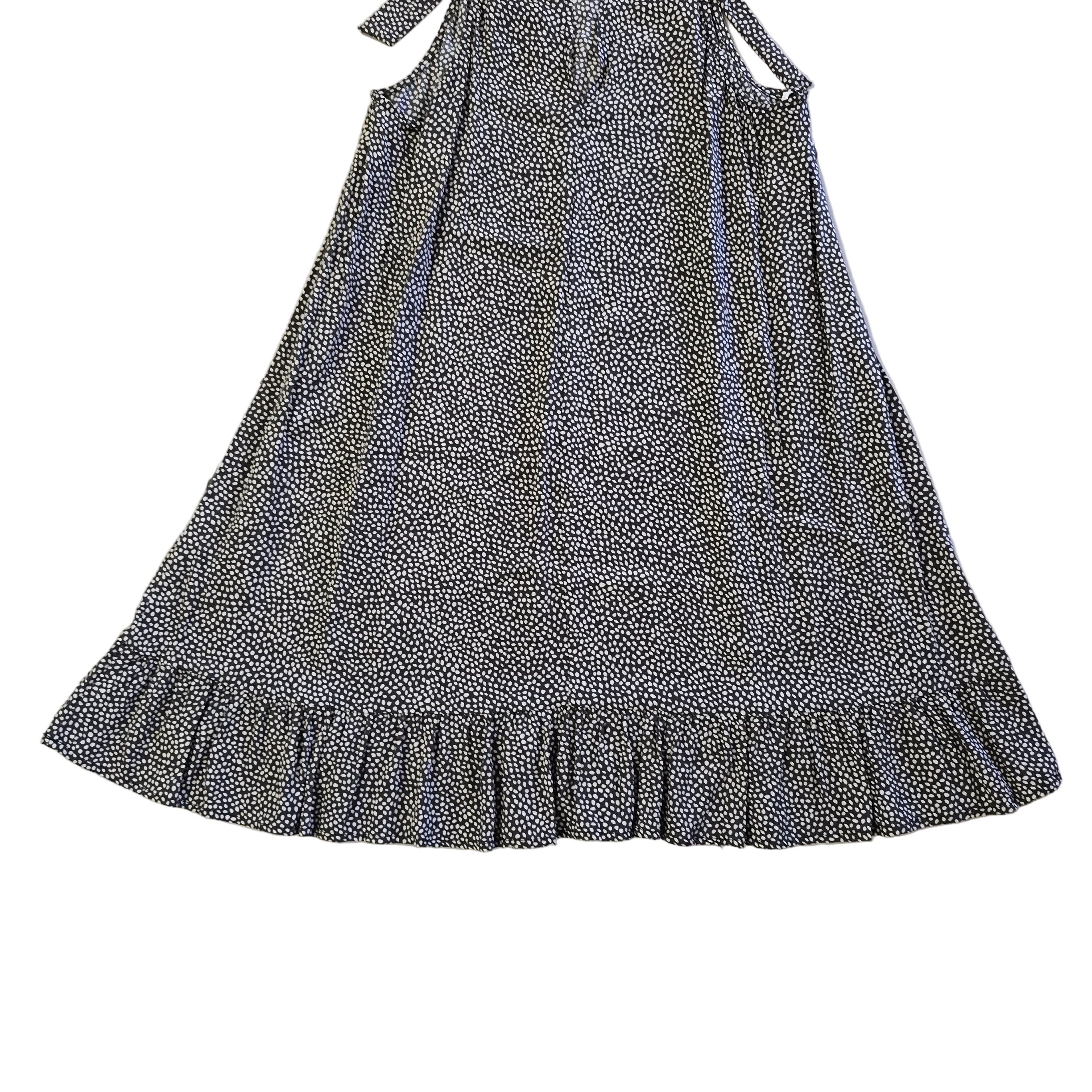 Black and white patterned dress on a tiled floor