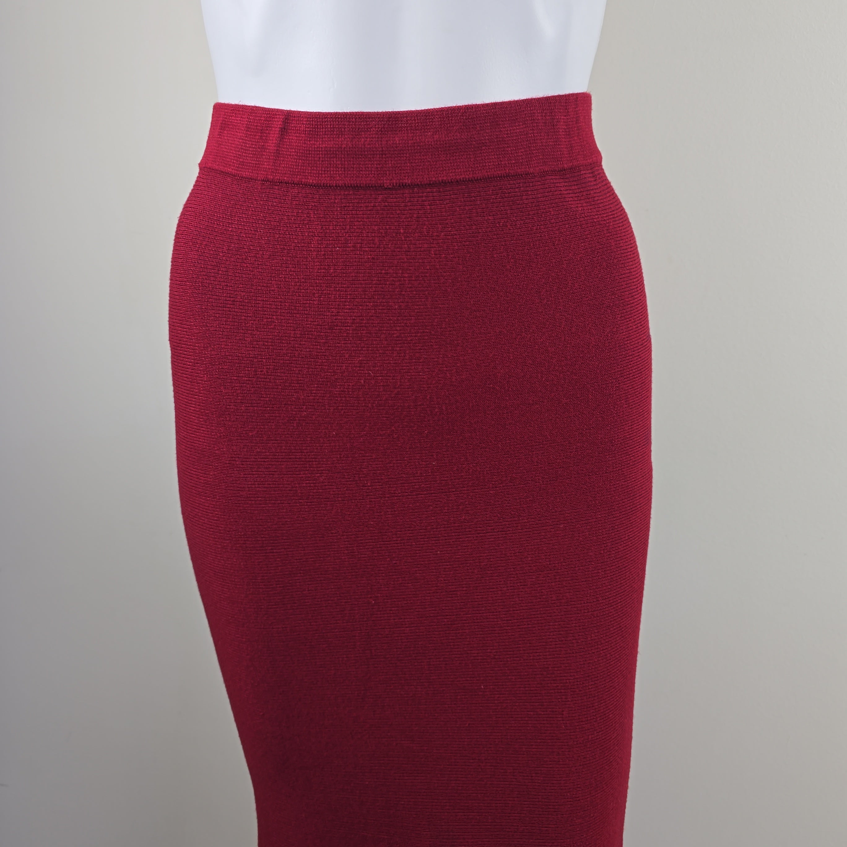 Close-up of a red skirt with a white shirt underneath on a neutral background