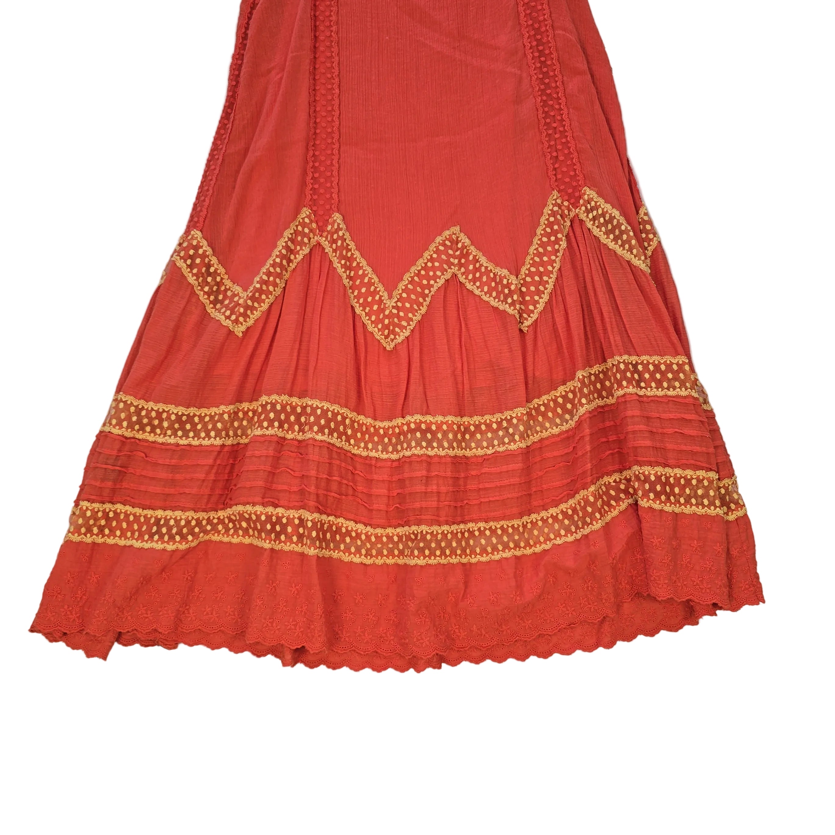 Orange dress with yellow lace embroidery on a light background