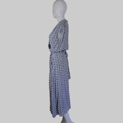 Blue patterned tie on a mannequin head against a white wall